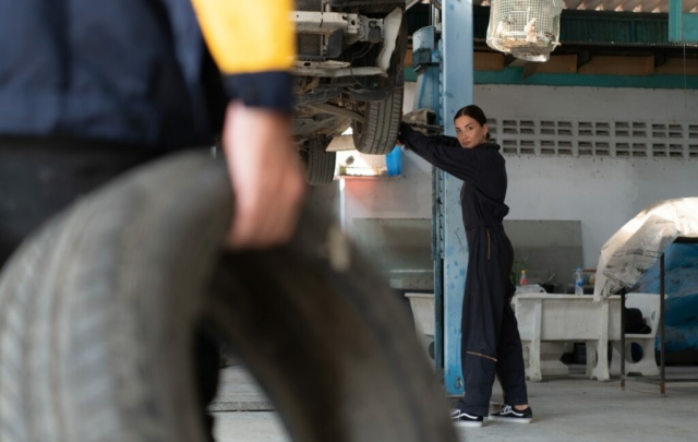A car mechanic inspects the condition of a car tire before placing it on a vehicle.