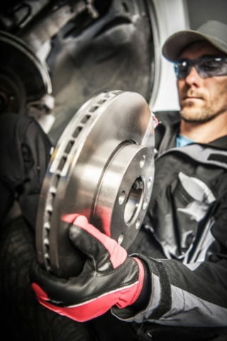 Car Mechanic Replacing Car Disc Brakes.