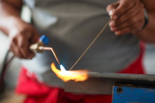 Mechanic welding in car workshop